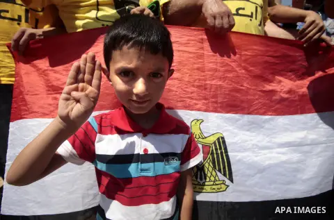 Palestinian supporters of the radical Islamist movement Hamas raise their hands and four fingers, a sign that protesters say symbolizes the Rabaah al-Adawiya mosque in Cairo that was cleared last week by Egyptian securit...