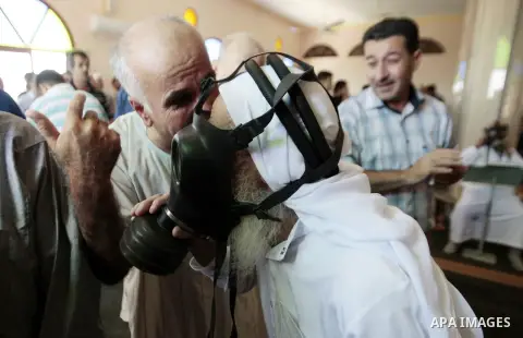 Palestinian worshipers cover their faces after inhaling tear gas fired by Israeli security forces at a mosque during Friday prayer in the village of Kfar Qaddum, near Nablus in the occupied West Bank on August 13, 2013....