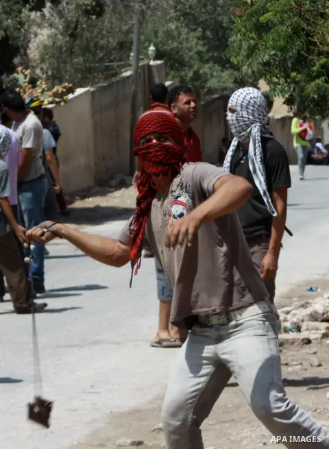 Palestinian protesters throw stones at Israeli security forces during clashes following a protest against the expropriation of Palestinian land by Israel in the village of Kfar Qaddum, near Nablus in the occupied West Ba...