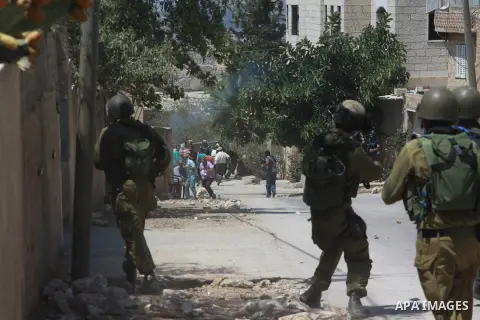 Israeli security forces fire tear gas towards Palestinian protesters during clashes following a protest against the expropriation of Palestinian land by Israel in the village of Kfar Qaddum, near Nablus in the occupied W...