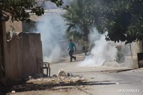 A Palestinian protester throws stones at Israeli security forces during clashes following a protest against the expropriation of Palestinian land by Israel in the village of Kfar Qaddum, near Nablus in the occupied West...