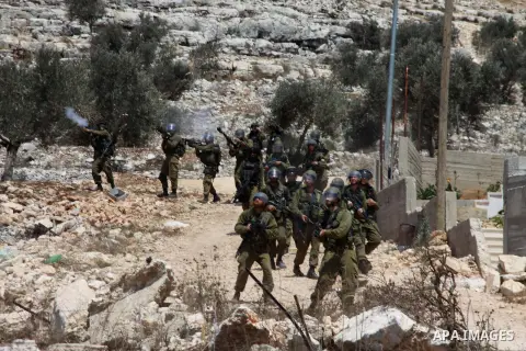 Israeli security forces run after Palestinian protesters during clashes following a protest against the expropriation of Palestinian land by Israel in the village of Kfar Qaddum, near Nablus in the occupied West Bank on...
