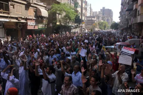 Egyptians supporters of ousted president Morsi hold posters depicting him during a Friday protest called for by the Muslim Brotherhood outside al-Aziz Bellah Mosque, Egypt, 23 August 2013. The four is a reference to the...