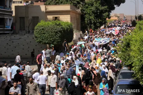 Egyptians supporters of ousted president Morsi hold posters depicting him during a Friday protest called for by the Muslim Brotherhood outside al-Aziz Bellah Mosque, Egypt, 23 August 2013. The four is a reference to the...