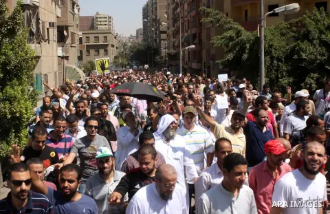 Egyptians supporters of ousted president Morsi hold posters depicting him during a Friday protest called for by the Muslim Brotherhood outside al-Aziz Bellah Mosque, Egypt, 23 August 2013. The four is a reference to the...