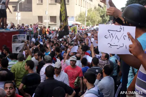 Egyptians supporters of ousted president Morsi hold posters depicting him during a Friday protest called for by the Muslim Brotherhood outside al-Aziz Bellah Mosque, Egypt, 23 August 2013. The four is a reference to the...