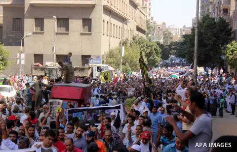 Egyptians supporters of ousted president Morsi hold posters depicting him during a Friday protest called for by the Muslim Brotherhood outside al-Aziz Bellah Mosque, Egypt, 23 August 2013. The four is a reference to the...