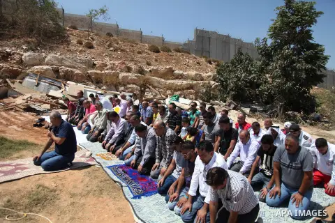 Palestinian from Ka'abneh Arabs attend Friday prayers in protest against evacuating them by Israeli bulldozers, in Bir Nabala near Jerusalem, Aug 23, 2013. Israeli authorities evacuated 53 Bedouin from residents of the c...