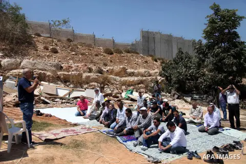 Palestinian from Ka'abneh Arabs attend Friday prayers in protest against evacuating them by Israeli bulldozers, in Bir Nabala near Jerusalem, Aug 23, 2013. Israeli authorities evacuated 53 Bedouin from residents of the c...