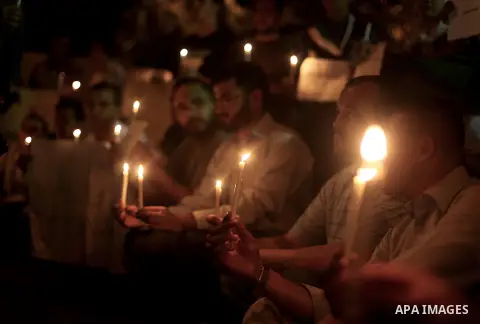 Palestinians hold lit candles during a protest against Syria's President Bashar al-Assad in front of the U.N. headquarters in Gaza City August 23, 2013. U.N. Secretary-General Ban Ki-moon said on Friday he intends to con...