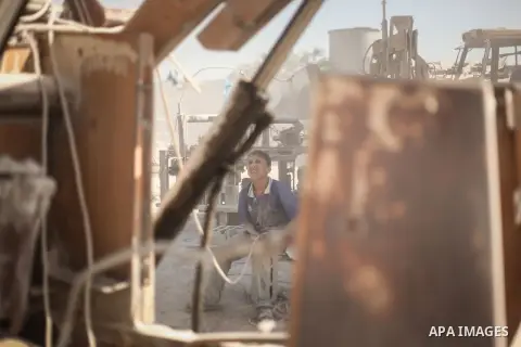 A Palestinian laborer works on a crusher machine at a brick factory in center Gaza Strip, Aug 22, 2013. Palestinians re-use old bricks in construction after the Egyptian army started to knock down Gaza smuggling tunnels...