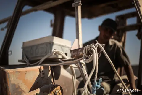 A Palestinian laborer works on a crusher machine at a brick factory in center Gaza Strip, Aug 22, 2013. Palestinians re-use old bricks in construction after the Egyptian army started to knock down Gaza smuggling tunnels...