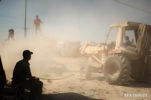 Palestinian laborers work on a crusher machine at a brick factory in center Gaza Strip, Aug 22, 2013. Palestinians re-use old bricks in construction after the Egyptian army started to knock down Gaza smuggling tunnels la...
