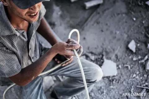 A Palestinian laborer works on a crusher machine at a brick factory in center Gaza Strip, Aug 22, 2013. Palestinians re-use old bricks in construction after the Egyptian army started to knock down Gaza smuggling tunnels...