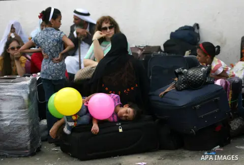 Palestinians wait to cross into Egypt at Rafah crossing between Egypt and southern Gaza Strip August 24, 2013. Egypt reopened its border crossing with the Gaza Strip on Saturday after four days of closure, allowing stran...