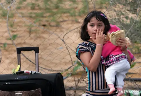 A Palestinian girl waits to cross into Egypt at Rafah crossing between Egypt and southern Gaza Strip August 24, 2013. Egypt reopened its border crossing with the Gaza Strip on Saturday after four days of closure, allowin...