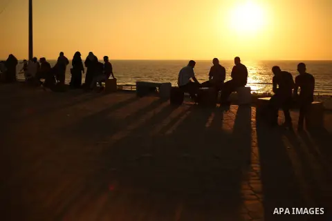 Palestinians enjoy sitting on the sea at Gaza beach during Friday holiday in Gaza city, Aug. 23, 2013. Gazans escape to the beach and out from their homes during heat wave and power outages. Photo by Mahmoud Hamda