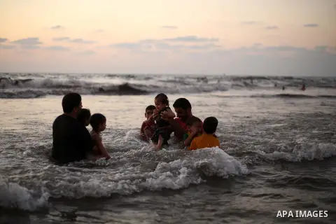 Palestinians enjoy swimming in the sea at Gaza beach during Friday holiday in Gaza city, Aug. 23, 2013. Gazans escape to the beach and out from their homes during heat wave and power outages. Photo by Mahmoud Hamda