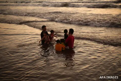 Palestinians enjoy swimming in the sea at Gaza beach during Friday holiday in Gaza city, Aug. 23, 2013. Gazans escape to the beach and out from their homes during heat wave and power outages. Photo by Mahmoud Hamda