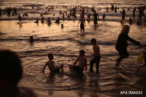 Palestinians enjoy swimming in the sea at Gaza beach during Friday holiday in Gaza city, Aug. 23, 2013. Gazans escape to the beach and out from their homes during heat wave and power outages. Photo by Mahmoud Hamda