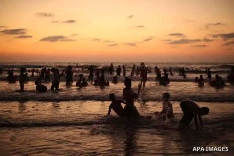 Palestinians enjoy swimming in the sea at Gaza beach during Friday holiday in Gaza city, Aug. 23, 2013. Gazans escape to the beach and out from their homes during heat wave and power outages. Photo by Mahmoud Hamda