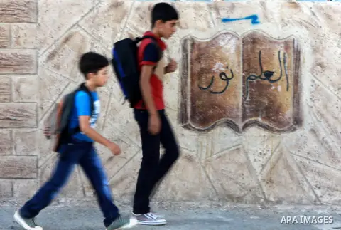 Palestinian students return back to their school in the morning of the first day of the new year study in the West Bank city of Nablus, on Aug. 25, 2013. Photo by Nedal Eshtayah