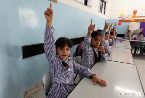 Palestinian students return back to their school in the morning of the first day of the new year study in the West Bank city of Ramallah, on Aug. 25, 2013. Photo by Issam Rimawi