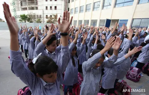 Palestinian students return back to their school in the morning of the first day of the new year study in the West Bank city of Ramallah, on Aug. 25, 2013. Photo by Issam Rimawi