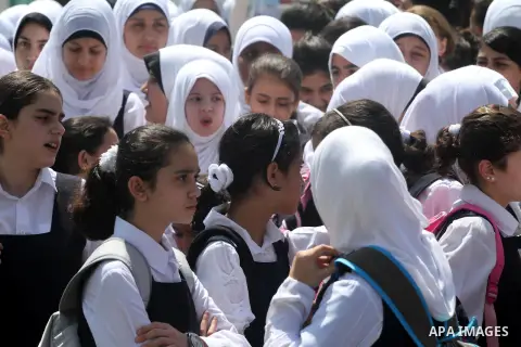 Palestinian students return back to their school in the morning of the first day of the new year study in Gaza city, on Aug. 25, 2013. Photo by Mohammed Asad