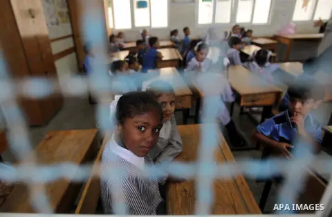 Palestinian school children attend a class at a U.N.-run school in Dir al-Balah in the central Gaza Strip, on the first day of the school year August 25, 2013. Photo by Ashraf Amra