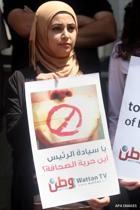 Palestinian journalists gather in front of the Interior Ministry in the West Bank city of Ramallah on August 25, 2013, to protest against the harassment of on-duty journalists and photographers by security forces. Photo...