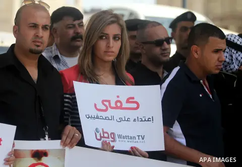 Palestinian journalists gather in front of the Interior Ministry in the West Bank city of Ramallah on August 25, 2013, to protest against the harassment of on-duty journalists and photographers by security forces. Photo...