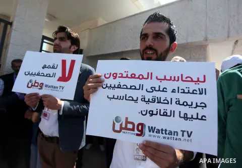 Palestinian journalists gather in front of the Interior Ministry in the West Bank city of Ramallah on August 25, 2013, to protest against the harassment of on-duty journalists and photographers by security forces. Photo...