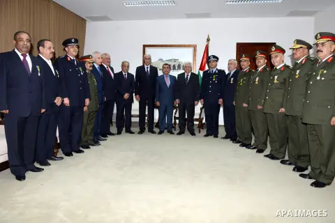 Palestinian President Mahmoud Abbas poses for a photograph with the former security chiefs following honoring ceremony in the West Bank City of Ramallah, Aug 25, 2013. Photo by Thaer Ganaim