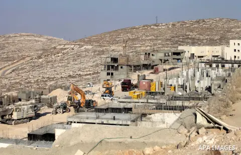 Laborers work at the construction site in Pisgat Zeev, an urban settlement in an area Israel annexed to Jerusalem after capturing it in the 1967 Middle East war, near the Arab village of Beit Hanina, August 25, 2013. Pal...