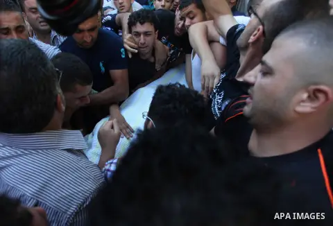 Relatives mourn the deaths of two Palestinians shot dead by Israeli troops, at a hospital in the West Bank city of Ramallah August 26, 2013. Israeli troops on Monday shot dead two Palestinians and wounded more than a doz...
