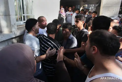 Relatives mourn the deaths of two Palestinians shot dead by Israeli troops, at a hospital in the West Bank city of Ramallah August 26, 2013. Israeli troops on Monday shot dead two Palestinians and wounded more than a doz...