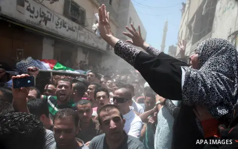 Palestinian mourners carry the bodies of Robin Zayed, Younis Jahjouh and Jihad Aslan during their funeral at Qalandiya Refugee Camp near the West Bank city of Ramallah August 26, 2013. Israeli troops shot dead three Pale...