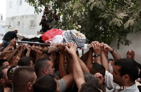 Palestinian mourners carry the bodies of Robin Zayed, Younis Jahjouh and Jihad Aslan during their funeral at Qalandiya Refugee Camp near the West Bank city of Ramallah August 26, 2013. Israeli troops shot dead three Pale...