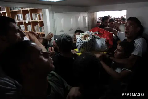 Palestinian mourners carry the bodies of Robin Zayed, Younis Jahjouh and Jihad Aslan during their funeral at Qalandiya Refugee Camp near the West Bank city of Ramallah August 26, 2013. Israeli troops shot dead three Pale...