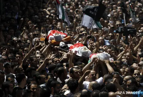 Palestinian mourners carry the bodies of Robin Zayed, Younis Jahjouh and Jihad Aslan during their funeral at Qalandiya Refugee Camp near the West Bank city of Ramallah August 26, 2013. Israeli troops shot dead three Pale...