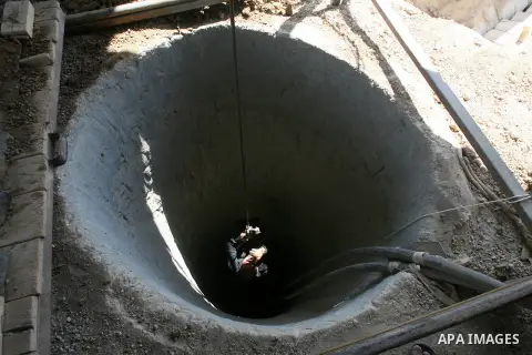 A Palestinian tunnel worker is lowered on a rope into a smuggling tunnel dug beneath the Gaza-Egypt border in the southern Gaza Strip on August 27, 2013. Egyptian security forces have stepped up a crackdown campaign on s...