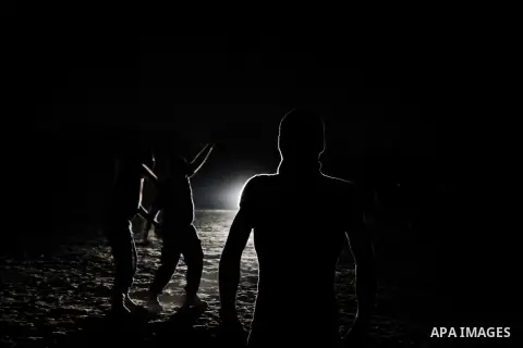 Palestinian militants of al-Nasser Salah al-Din Brigades, the armed wing of the Popular Resistance Committees (PRC), take part in a night military-style exercises at a training camp in Rafah in the southern Gaza Strip, A...