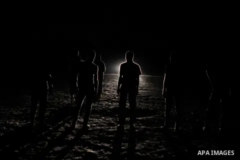 Palestinian militants of al-Nasser Salah al-Din Brigades, the armed wing of the Popular Resistance Committees (PRC), take part in a night military-style exercises at a training camp in Rafah in the southern Gaza Strip, A...