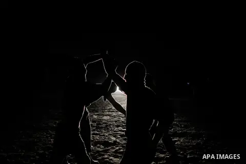 Palestinian militants of al-Nasser Salah al-Din Brigades, the armed wing of the Popular Resistance Committees (PRC), take part in a night military-style exercises at a training camp in Rafah in the southern Gaza Strip, A...