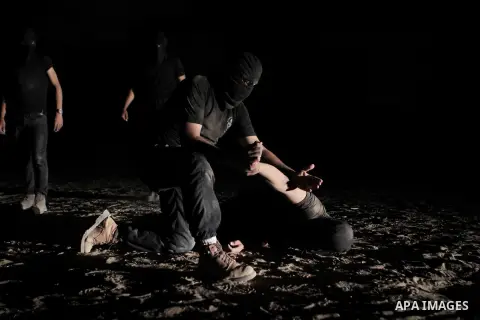 Palestinian militants of al-Nasser Salah al-Din Brigades, the armed wing of the Popular Resistance Committees (PRC), take part in a night military-style exercises at a training camp in Rafah in the southern Gaza Strip, A...
