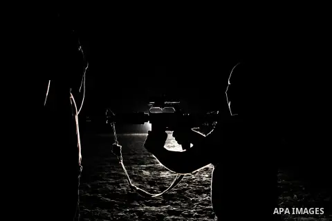 Palestinian militants of al-Nasser Salah al-Din Brigades, the armed wing of the Popular Resistance Committees (PRC), take part in a night military-style exercises at a training camp in Rafah in the southern Gaza Strip, A...