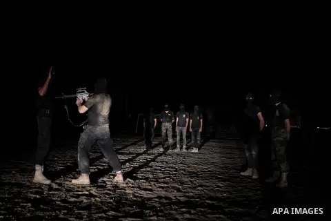 Palestinian militants of al-Nasser Salah al-Din Brigades, the armed wing of the Popular Resistance Committees (PRC), take part in a night military-style exercises at a training camp in Rafah in the southern Gaza Strip, A...