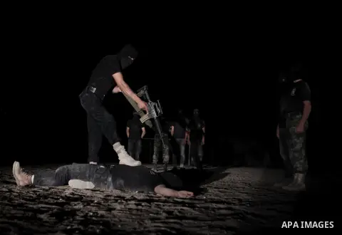 Palestinian militants of al-Nasser Salah al-Din Brigades, the armed wing of the Popular Resistance Committees (PRC), take part in a night military-style exercises at a training camp in Rafah in the southern Gaza Strip, A...