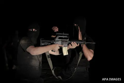 Palestinian militants of al-Nasser Salah al-Din Brigades, the armed wing of the Popular Resistance Committees (PRC), take part in a night military-style exercises at a training camp in Rafah in the southern Gaza Strip, A...